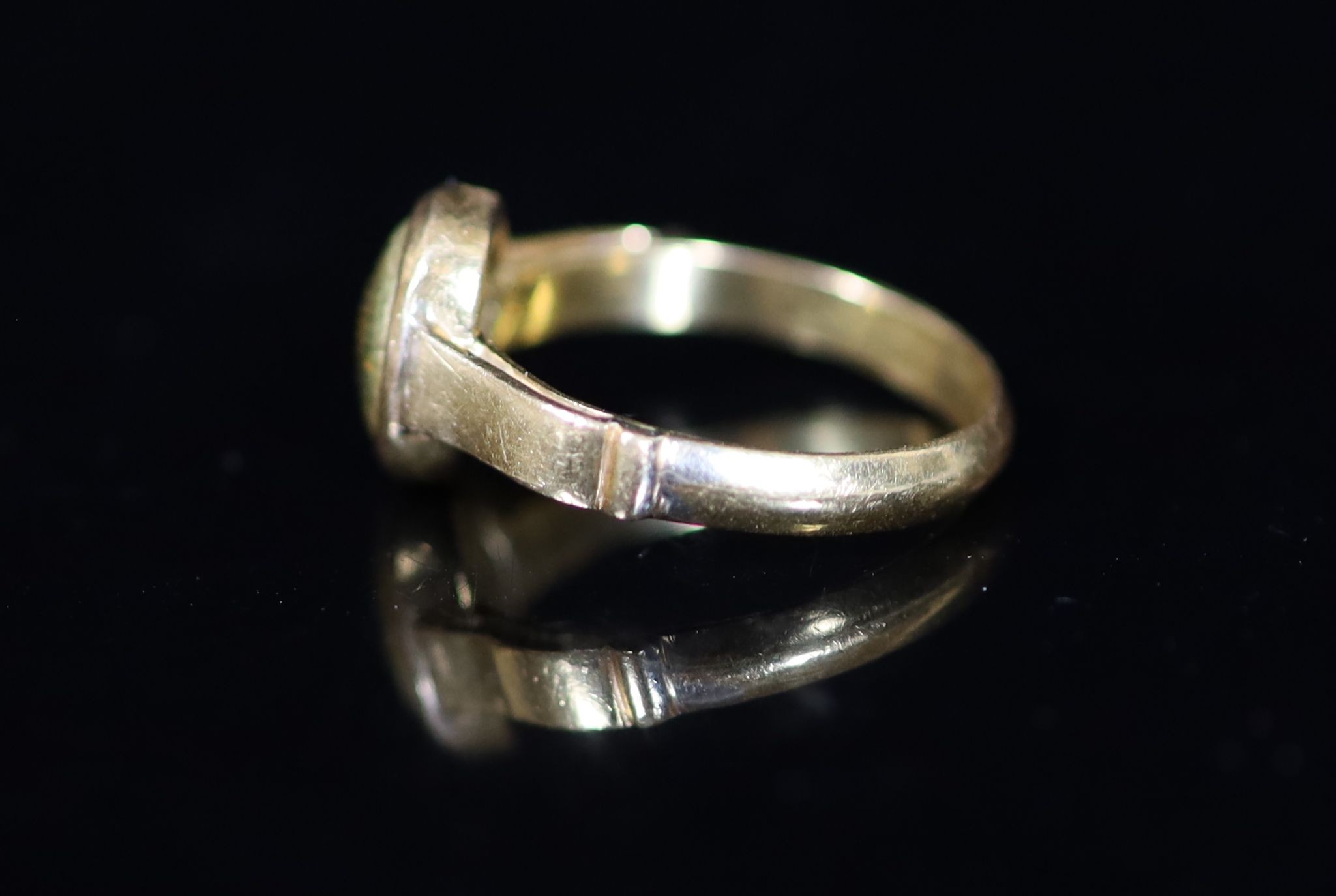 An antique gold ring, the centre now with gold? (ex gemstone) insert